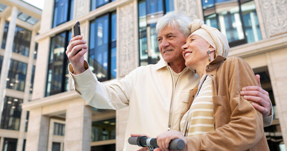 senior couple riding electric scooter city taking selfie
